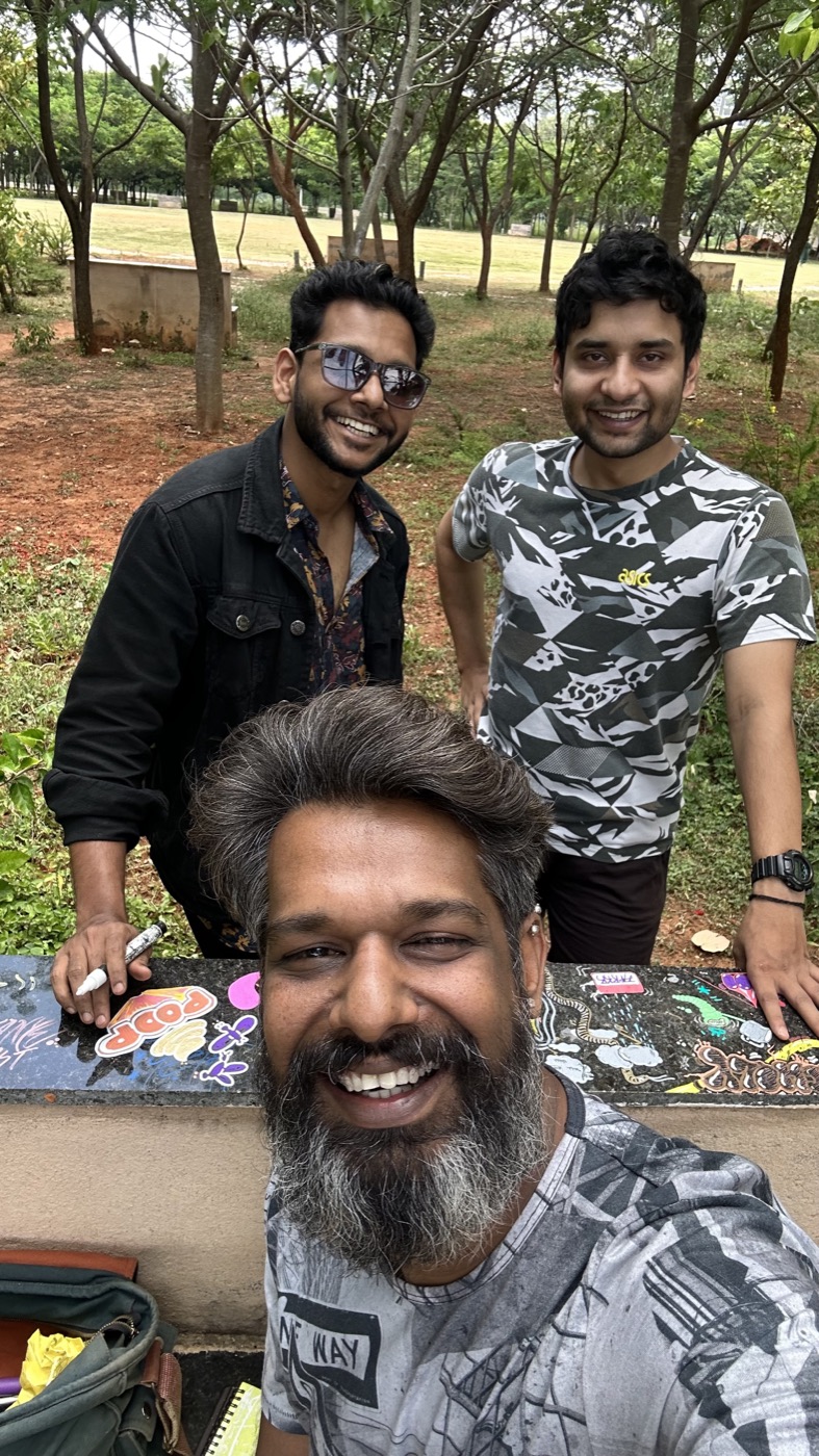 Three team members taking a playful street selfie